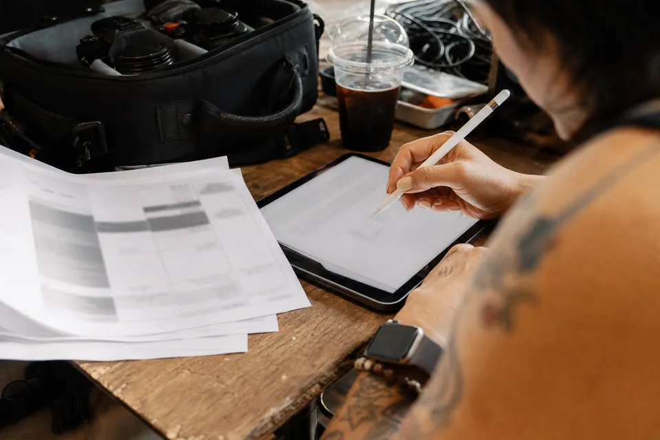 Brand manager and model reviewing a booking agreement on a tablet